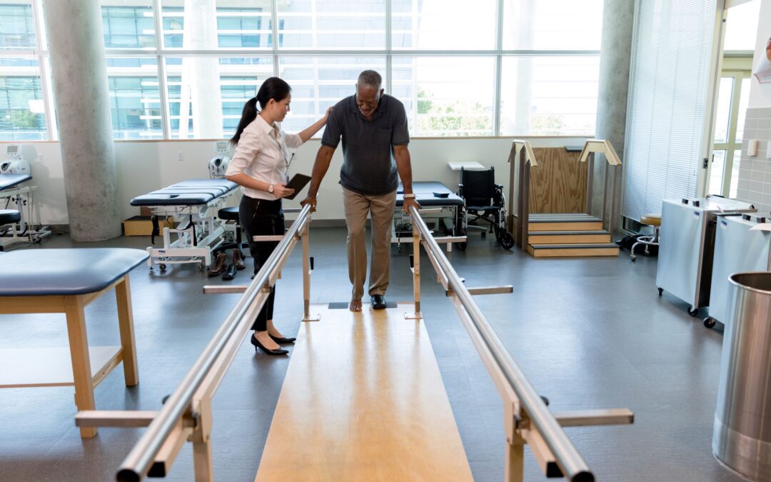 A therapist helps a stroke patient walk. Stroke therapy can help individuals regain motor skills.